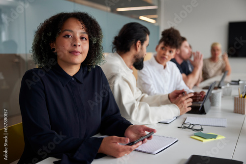 Woman sitting during business meeting and looking at camera photo
