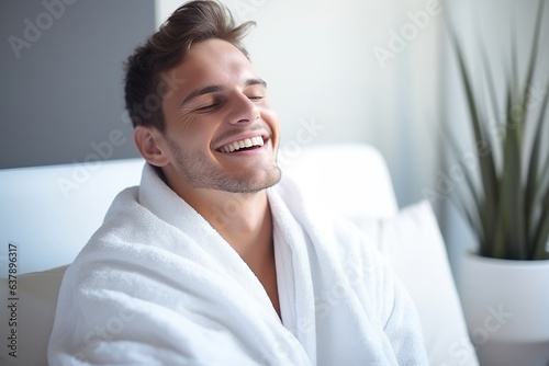 Refreshed young man using a bath towel after a shower