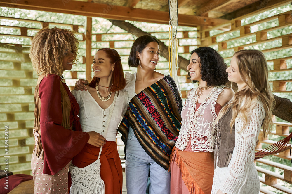 women retreat, happy multiethnic girlfriends in boho style outfit looking at each other in cottage women retreat, happy multiethnic girlfriends in boho style outfit looking at each other in cottage