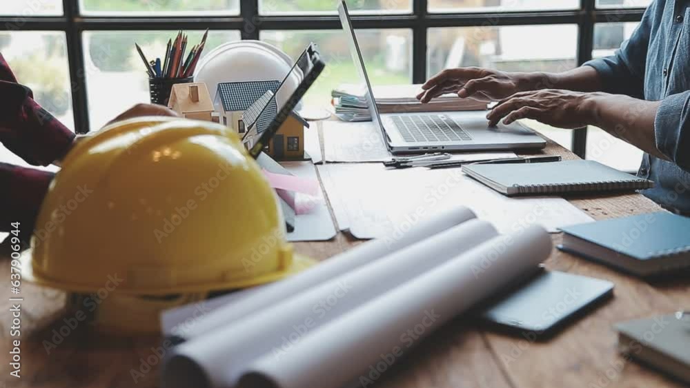 Image of team engineer checks construction blueprints on new project with engineering tools at desk in office.