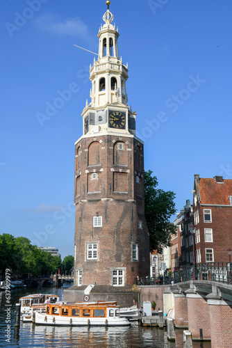 Photography Montelbaanstoren tower at a channel in the center of Amsterdam on Holland
