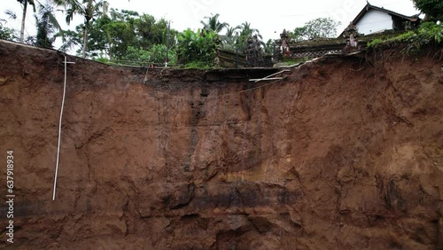 Water is leaking from old irrigation ditch and enters ground. This may be one of main causes of local landslide that destroyed village road. Unique aerial view, low angle camera shows edge of fault photo