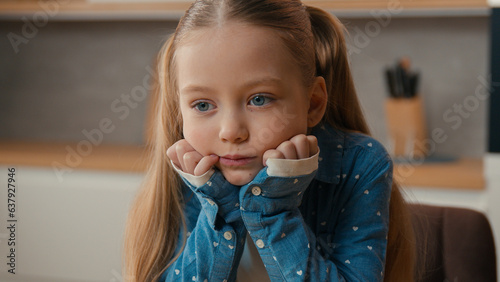 Fotografie Close up portrait little offended Caucasian sad upset bored child girl schoolgir