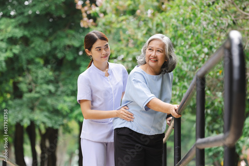 A nurse assisting an elderly patient in practicing walking by holding onto an iron railing is engaging in a common rehabilitation technique called gait training. 