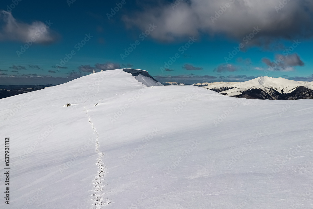 Footprints on the snowy mountain trail 