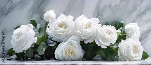 Beautiful white flowers, roses, over marble background. Bouquet of flowers at cemetery , funeral concept.