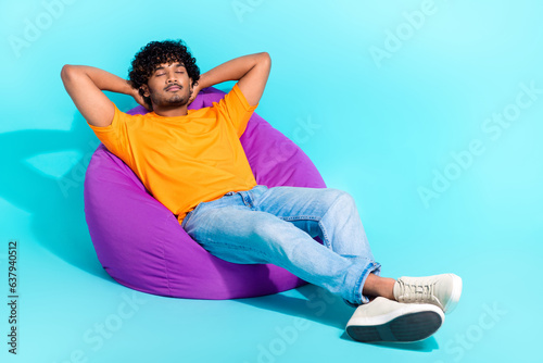 Full body photo of nice calm peaceful person sleep comfy bag hands behind head isolated on teal color background