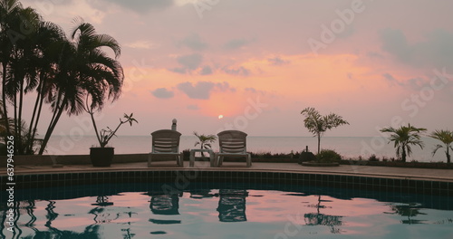 Quadro su tela Woman relaxes sitting near pool on tropical island hotel resort