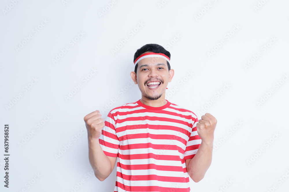 Naklejka premium Indonesian man clenched both fist showing excitement when celebrating independence day