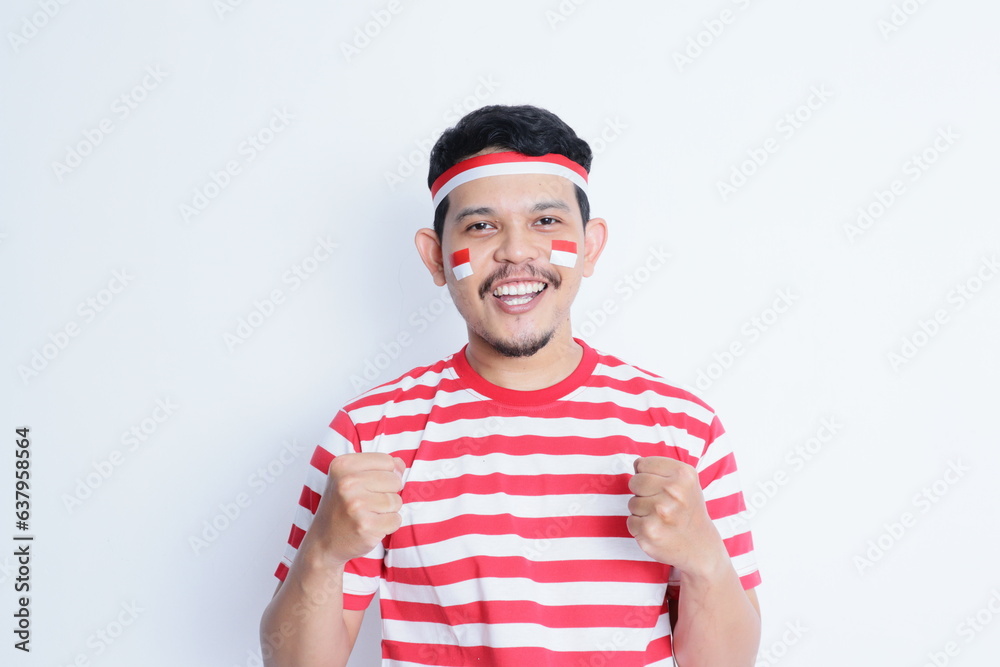 Naklejka premium Indonesian man clenched both fist showing excitement when celebrating independence day