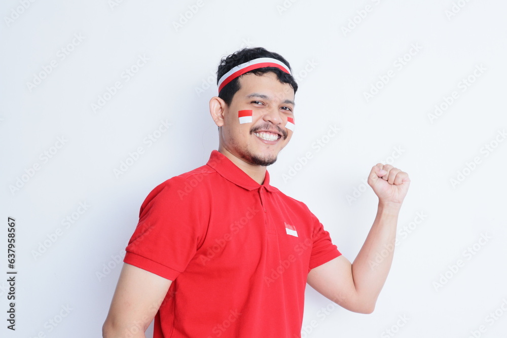 Indonesian man clenched fist showing proud expression during independence day celebration Indonesian man clenched fist showing proud expression during independence day celebration