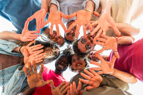 Hands in connecting of multiracial young people - Circle of open hands against face friends – multiracial friends hands connecting – multicultural young people open hands in circle 