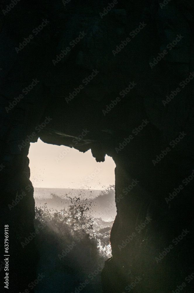 Detail of the Keyhole arch at Pfeiffer beach, with the setting sun to be just behind it.