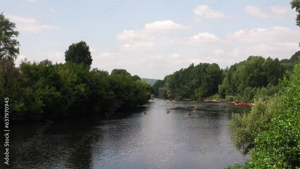 wide river with kayaks among green banks. Perigord, France wide river with kayaks among green banks. Perigord, France