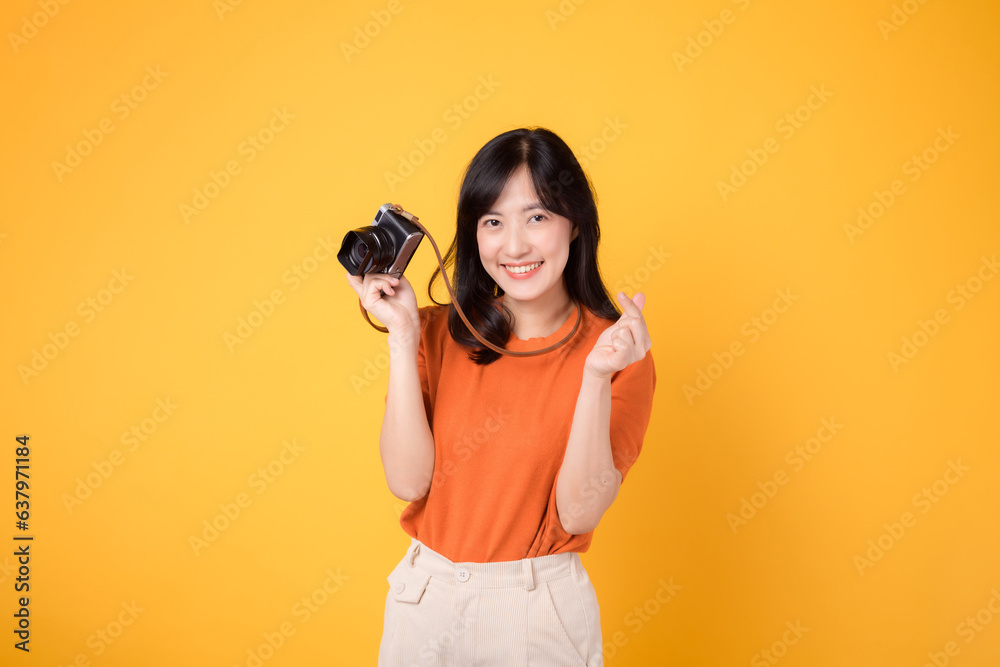 Young woman with a joyful smile, holding a camera for her exciting holiday journey. Young woman with a joyful smile, holding a camera for her exciting holiday journey.