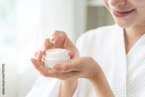 Fototapeta Naklejka Na Ścianę i Meble -  Close-up woman using skin care serum cream in daily routine.