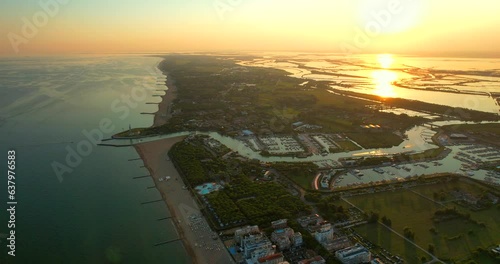 Italy, Jesolo. Lido di Jesolo, or Jesolo Lido, Europe beach and city area of city of Jesolo in the province of Venice, Aerial fly to sea footage in evening in HDR, HFR