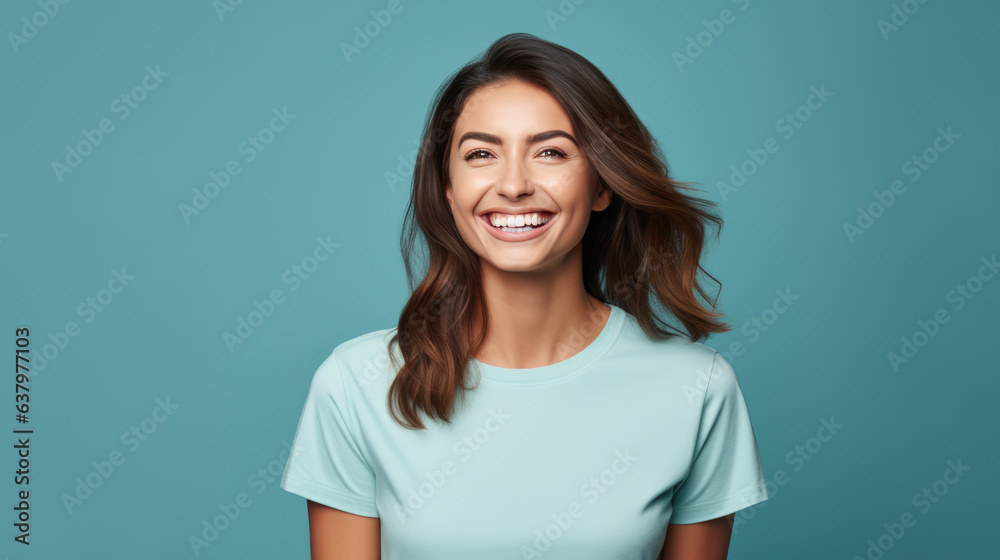 Young female standing in front of camera in white T-shirt , isolated on blue background Young female standing in front of camera in white T-shirt , isolated on blue background