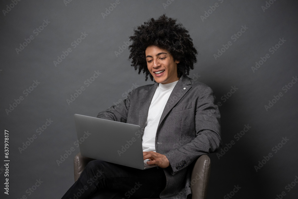 Young businessman working on laptop and looking involved Young businessman working on laptop and looking involved