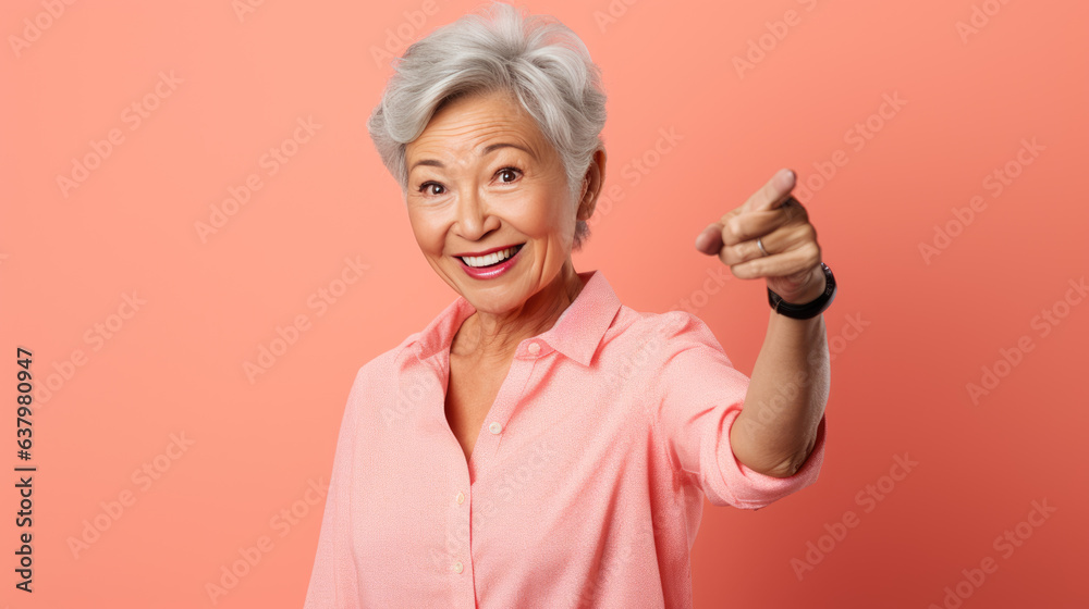 Senior woman wearing casual clothes pointing with hand and finger to the side looking at the camera. Senior woman wearing casual clothes pointing with hand and finger to the side looking at the camera.