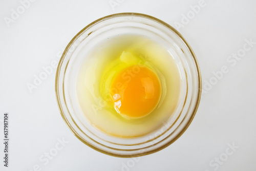 Raw egg, top view of one raw egg in a glass bowl