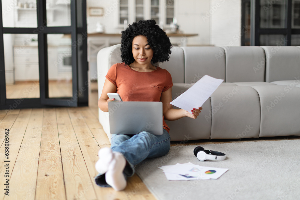 African American Freelancer Woman Working With Laptop And Documents At Home African American Freelancer Woman Working With Laptop And Documents At Home