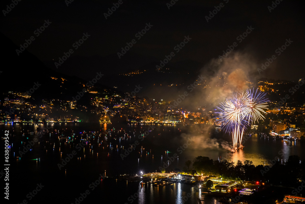 Night fireworks at the lake of Lugano, Switzerland. Celebrating first of August, Swiss National day