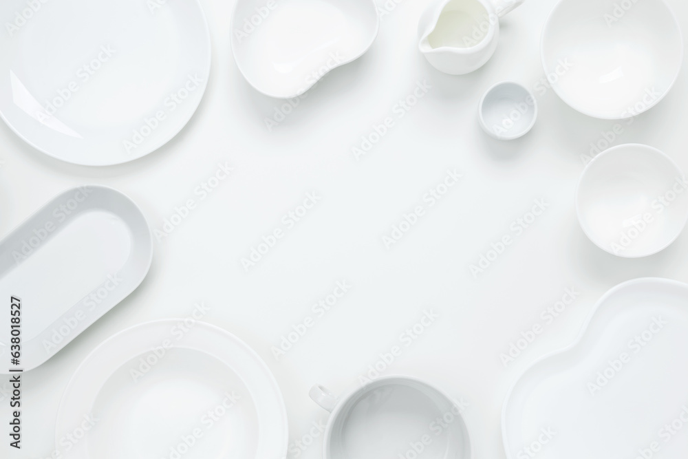 Set of different pure white dishes for home or restaurant on white background. Top view, flat lay, copy space Set of different pure white dishes for home or restaurant on white background. Top view, flat lay, copy space