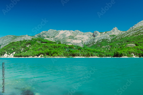 A beautiful mountain landscape, a view of the mountains and a lake with turquoise water, there is a place for an inscription. High quality photo © PopOff