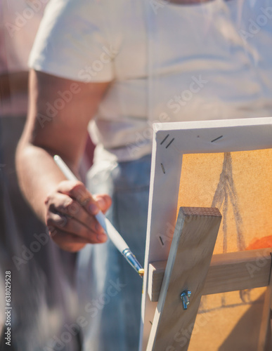 Process of drawing, group class of talented students with painting easels and canvases during lesson of watercolour painting outdoors, drawing class for adult artists in art school