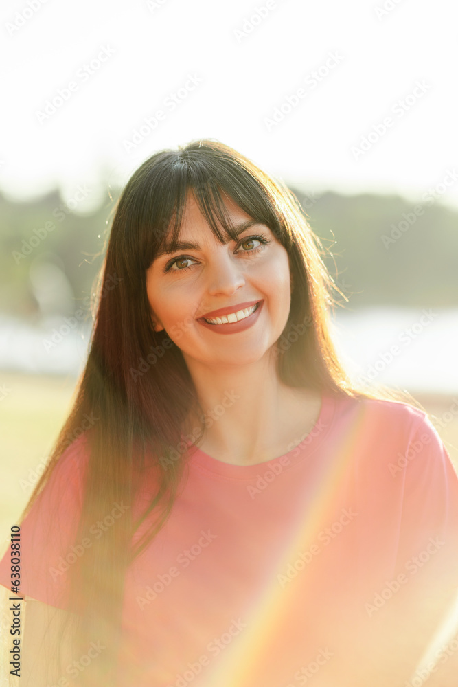 Portrait of attractive smiling woman with beautiful hair looking at camera