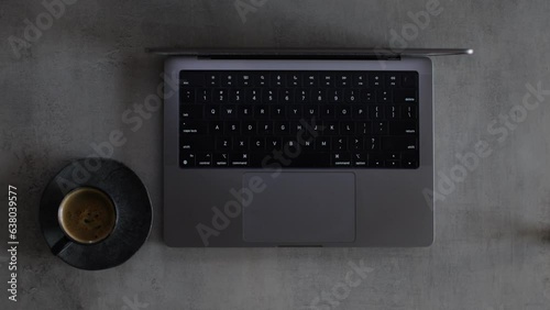 Businessman typing on a computer keyboard and drinking a coffee