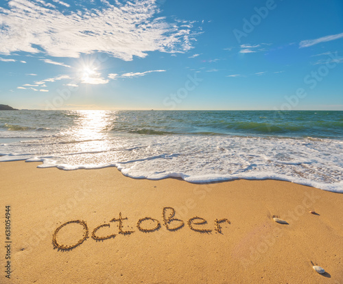 October word on sea sand