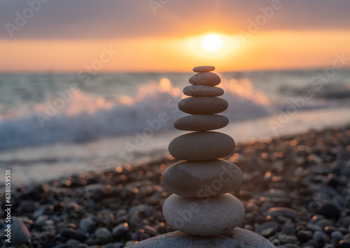 Pyramid of stones for meditation lying on sea coast at sunset © maxoidos