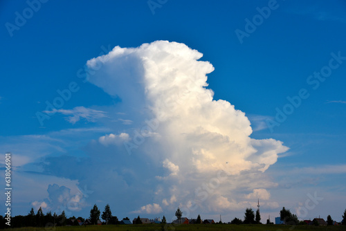 Beautiful thunderstorm landscape in the countryside. Thunderclouds and a horizon with a forest.