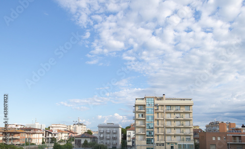 View of the city of Rimini from the balcony of a residential building against a blue sky with copy space