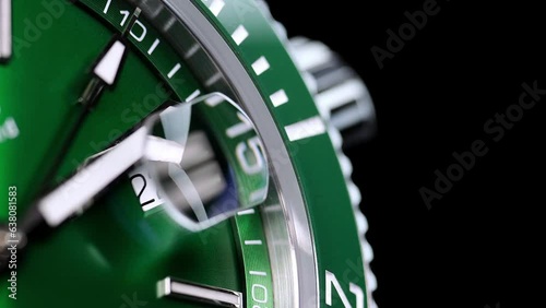 Stylish Luxury Man Wrist Watch With Moving Hand And Multiple Dials. Men's watch in metal with sapphire crystal. Closeup view of rotating watch, running second arrow. green dial. Cyclops watch