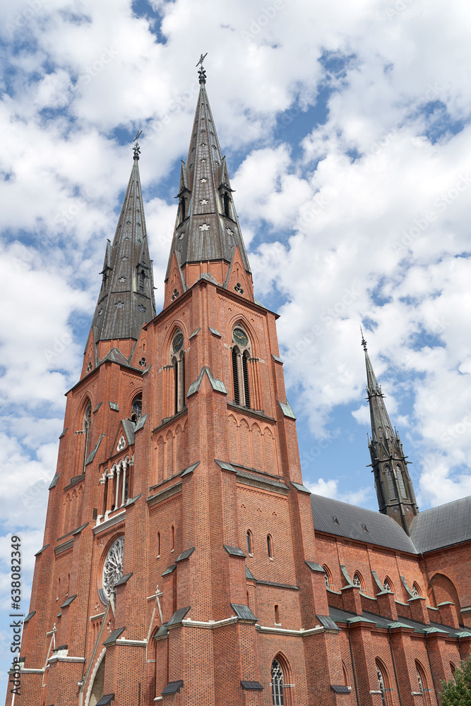Uppsala Cathedral in Uppsala, Sweden on sky with clouds background