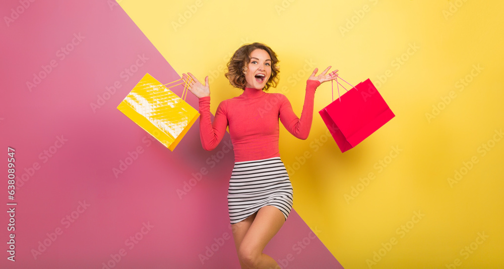 Fototapeta premium exited attractive woman in stylish colorful outfit holding shopping bags