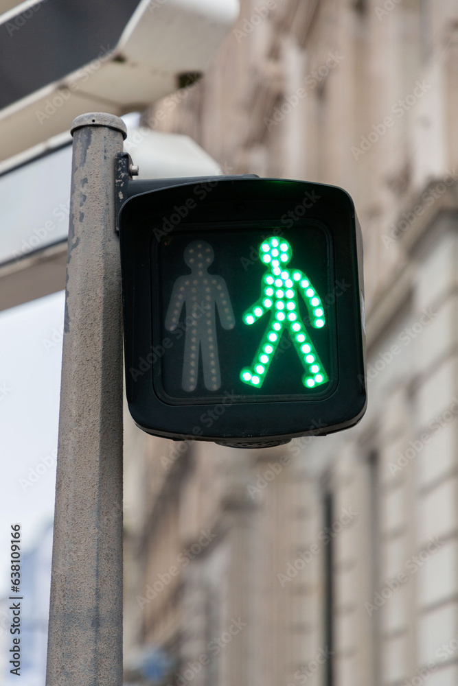 Green pedestrian light with a universal walking person