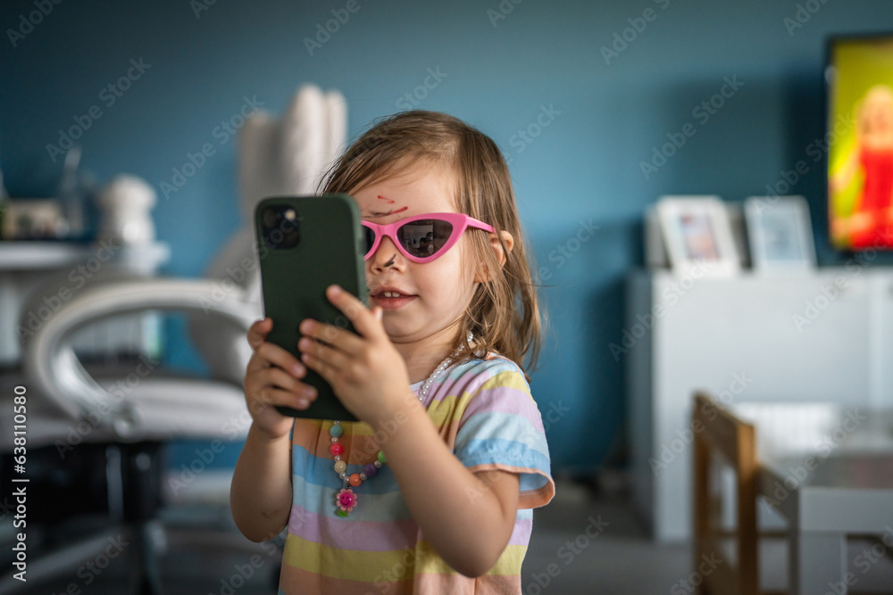 caucasian girl toddler with painted color draws and stains on face