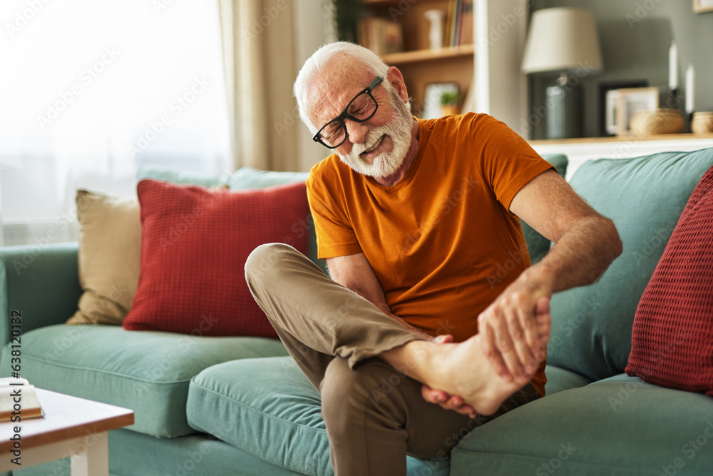 Senior man holding hands on ankle suffering from painful  joint ache