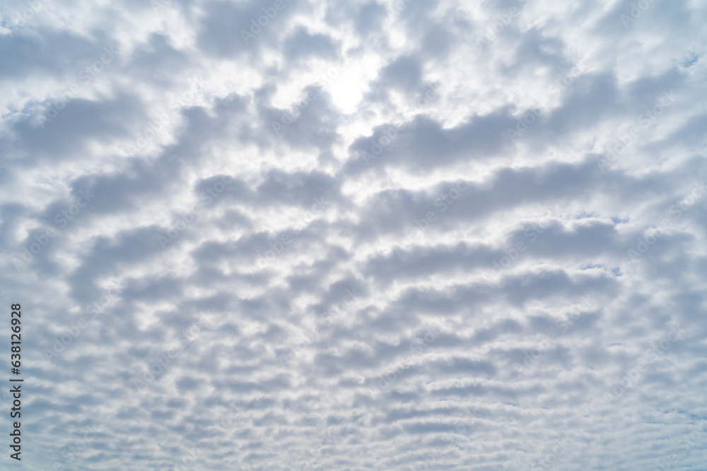 Clear blue sky with white fluffy clouds at noon. Day time. Abstract nature landscape background. Clear blue sky with white fluffy clouds at noon. Day time. Abstract nature landscape background.