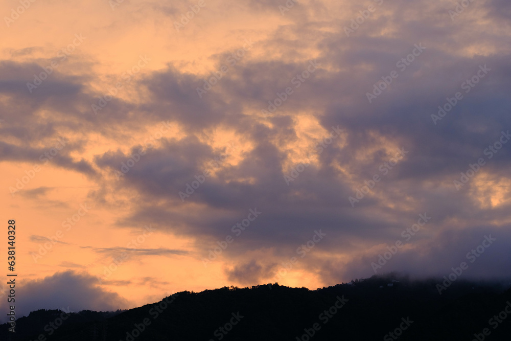 夜明け前、六甲の山並みと空。上空の雲が赤く染まり一日が始まる。早朝神戸市内から撮影