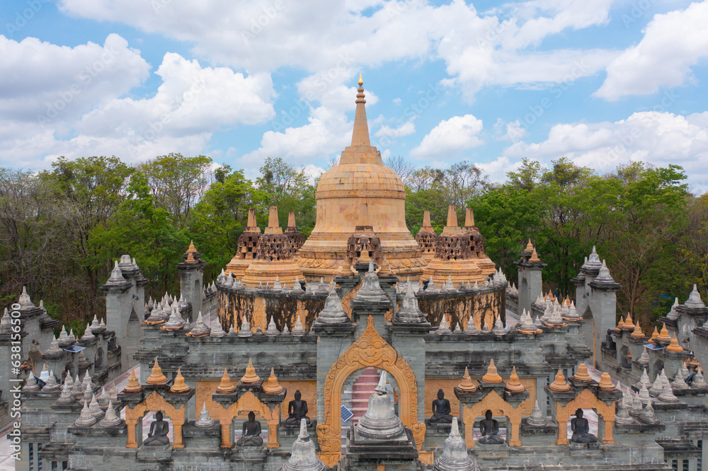 Fototapeta premium Wat Prachakom Wanaram (Wat Phakoong) temple pagoda is a buddhist temple in Roi et, an urban city town, Thailand. Thai architecture landscape background. Tourist attraction landmark.