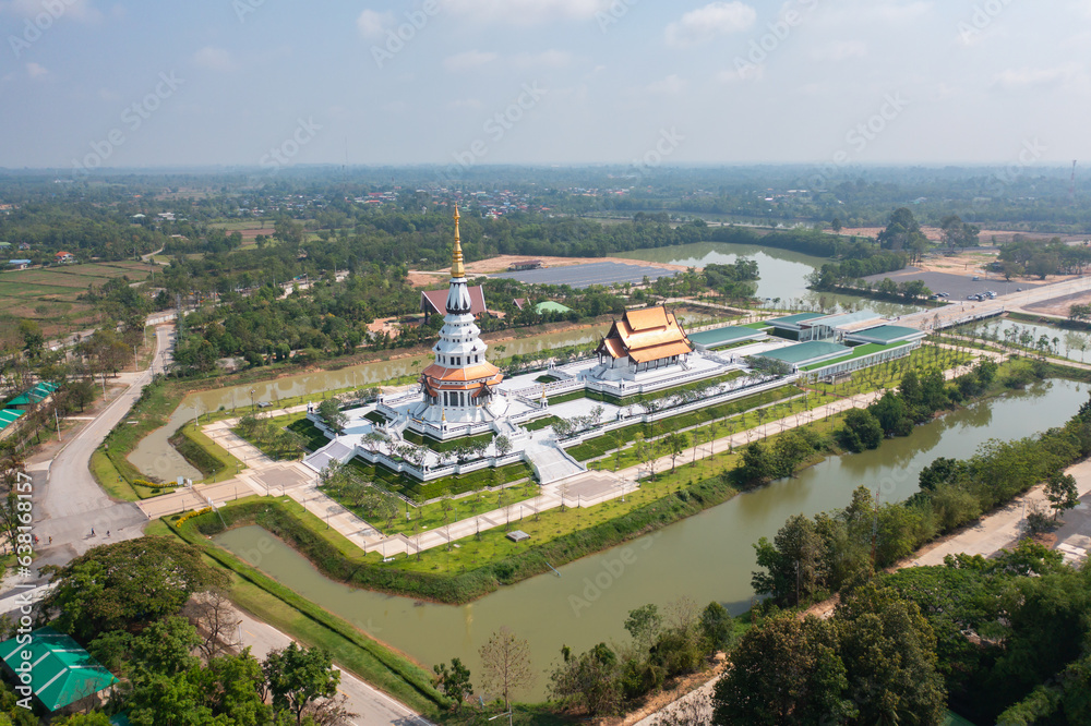 Aerial top view of Wat Pa Ban Tad, The Isan pagoda is a buddhist temple Udon Thani, an urban city town, Thailand. Thai architecture landscape background. Tourist attraction landmark.