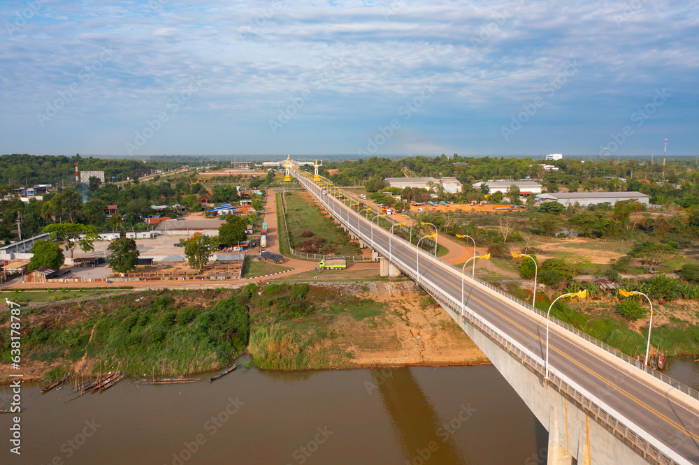 Aerial view of Thai Laos bridge with Mekong River with green mountain hill. Nature landscape background in Ubon Ratchathani, Thailand.