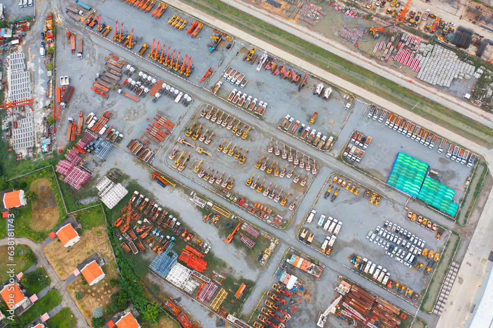 Aerial view of tractor truck cars in industrial factory for construction site.