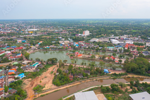 Fototapeta Naklejka Na Ścianę i Meble -  Aerial view of residential neighborhood roofs. Urban housing development from above. Top view. Real estate in Kalasin, Isan province city, Thailand. Property real estate.