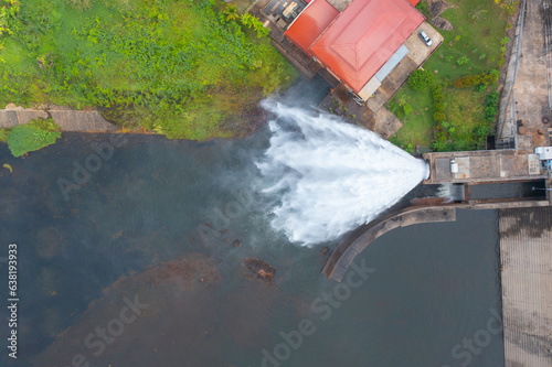 Aerial view of dam tower crane. Reservoir and sea water in recycle energy industry concept for electricity in Natural landscape background in Thailand. Environment.